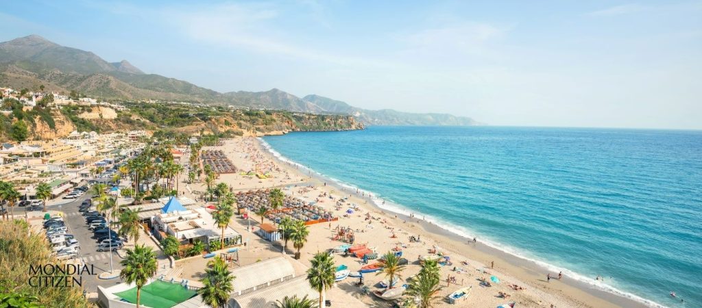 Sunny Mediterranean beach and coastal mountains in Spain for a Spain Non Lucrative Visa relocation guide